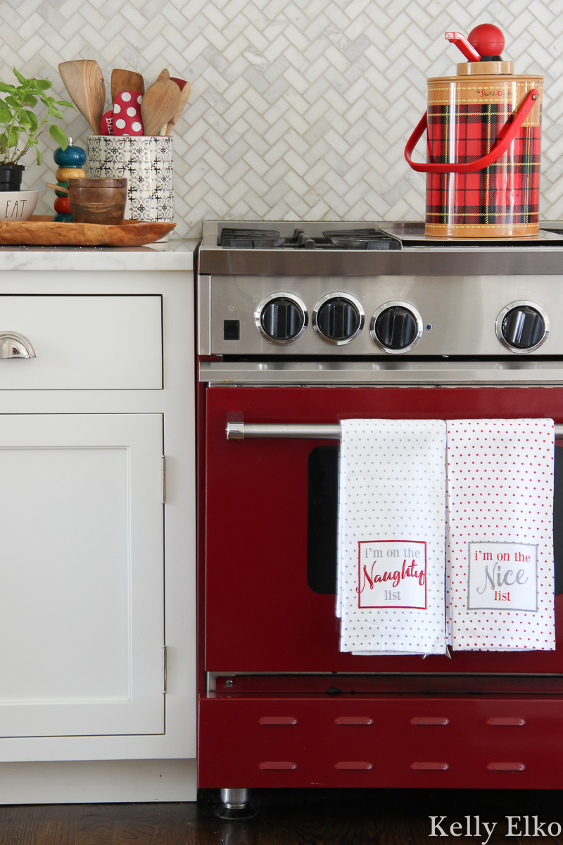 Love this red stove and the vintage Skotch thermos on top kellyelko.com #christmasdecor #vintagechristmas #redstove #vintagedecor #farmhousechristmas