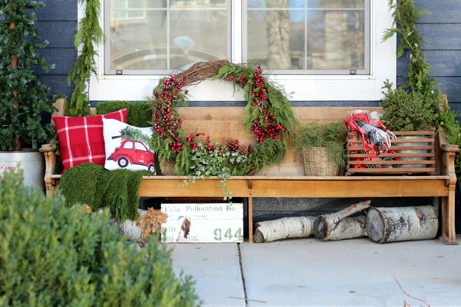 Love this old church pew on a front porch decked out for Christmas #christmas #christmasporch #vintagechristmas #farmhousechristmas #diywreath #christmaswreath 