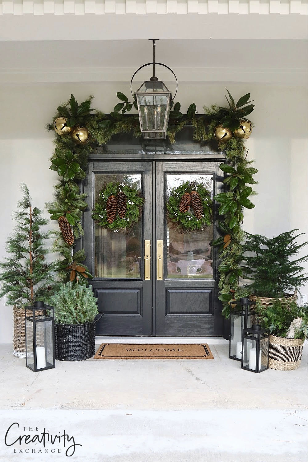 Love this classic Christmas porch with a twist! The giant pine cones and jingle bells add a festive touch #christmas #christmasporch #outdoorchristmasdecor #farmhousechristmas #classicchristmas #diychristmas #christmaswreath