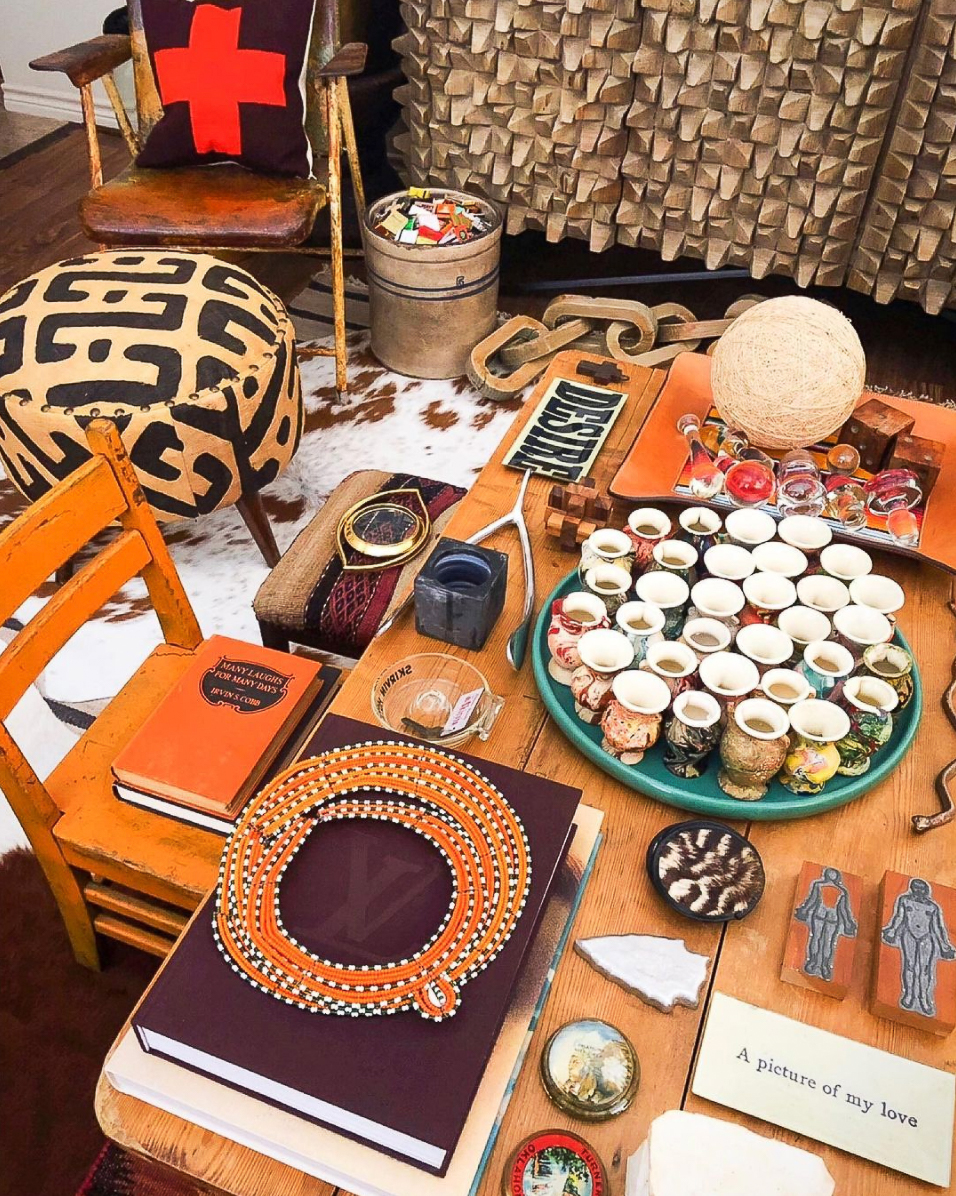 Love this cluttercore coffee table with an artful display of unique vintage finds 