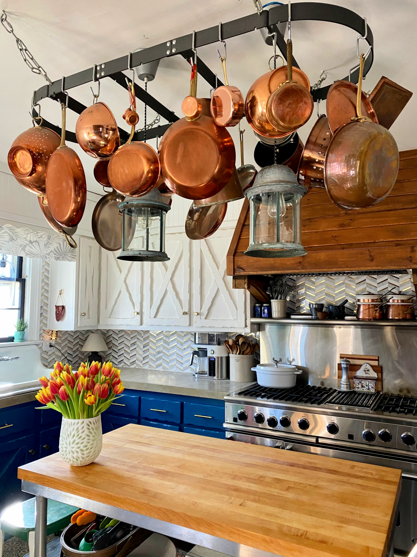 Eclectic Home Tour of Farmhouse 1820 - love the copper pots hung over the kitchen island 