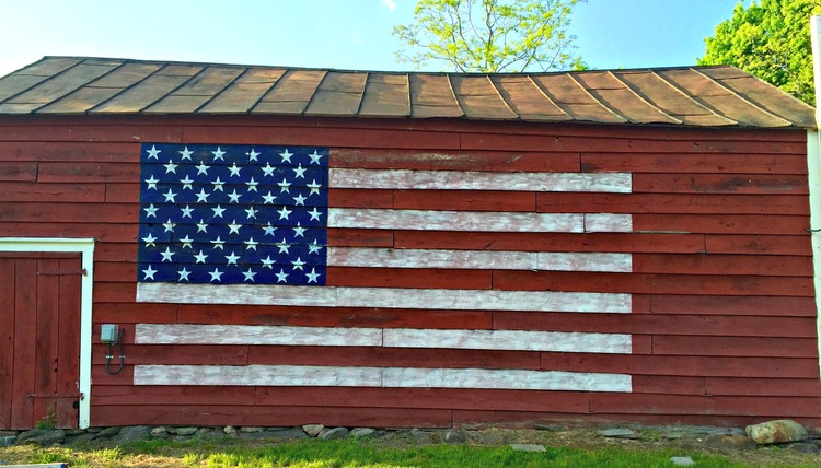 Big red barn with giant painted flag 