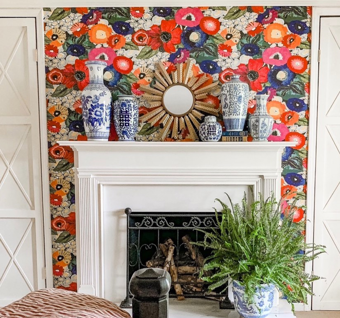 Bright and colorful floral wallpaper makes the mantel the focal point