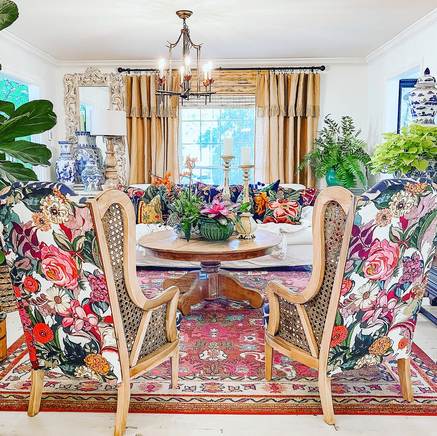 Colorful living room with thrifted cane chairs reupholstered in a fun and whimsical floral fabric 