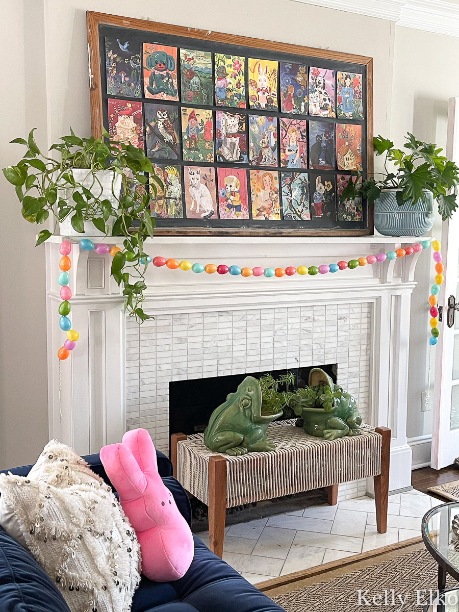 Love this colorful spring mantel with oversized art collage and a diy egg garland kellyelko.com