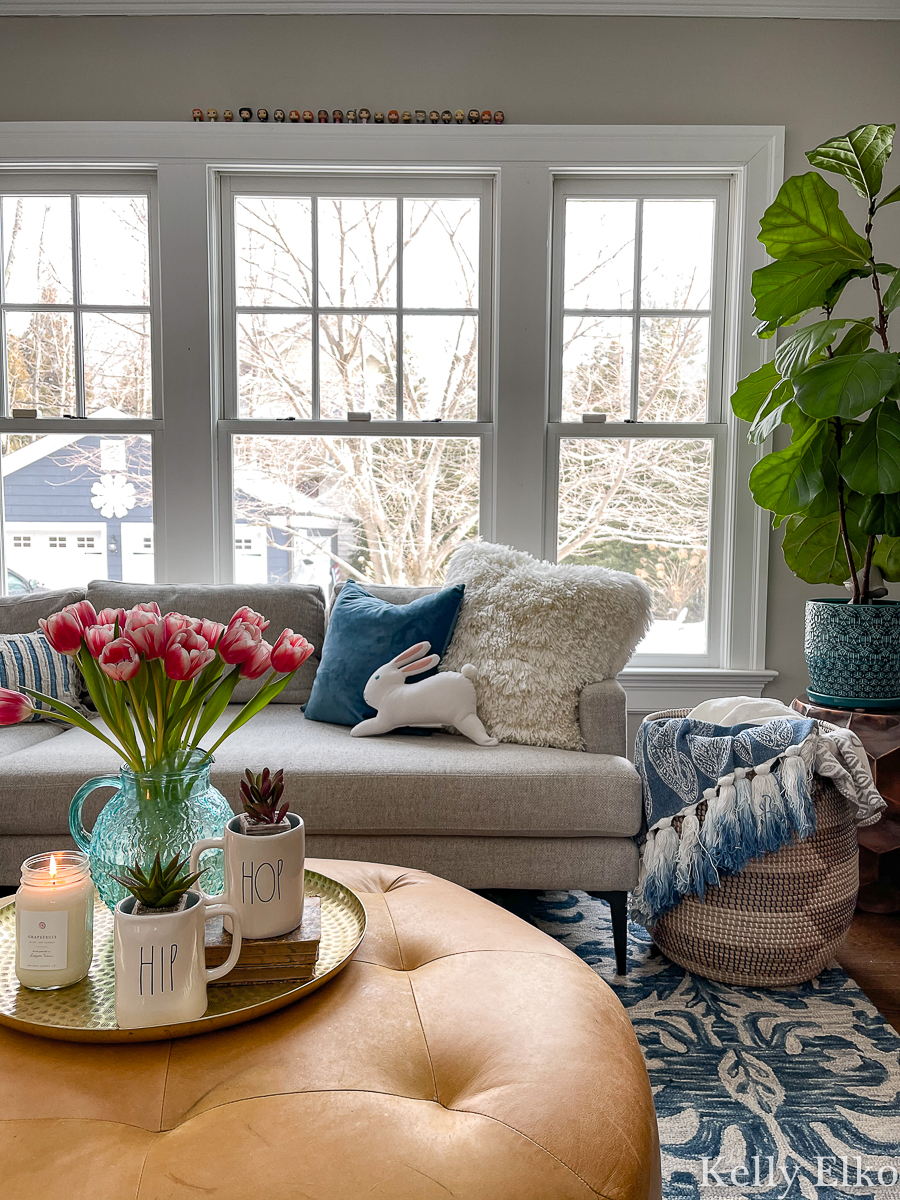 I love this colorful and eclectic family room for spring and the adorable little bunny pillow! kellyelko.com