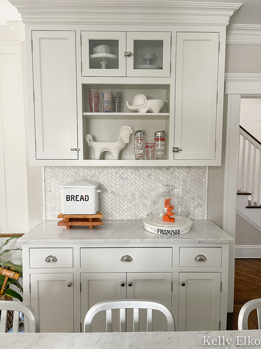 Farmhouse white kitchen with open shelves to display a vintage cocktail shaker collection kellyelko.com