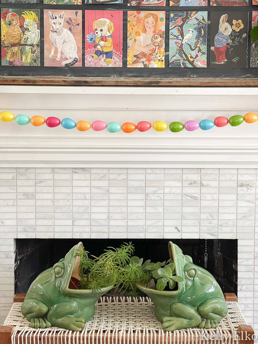 This spring mantel with egg garland and frog planters is adorable kellyelko.com