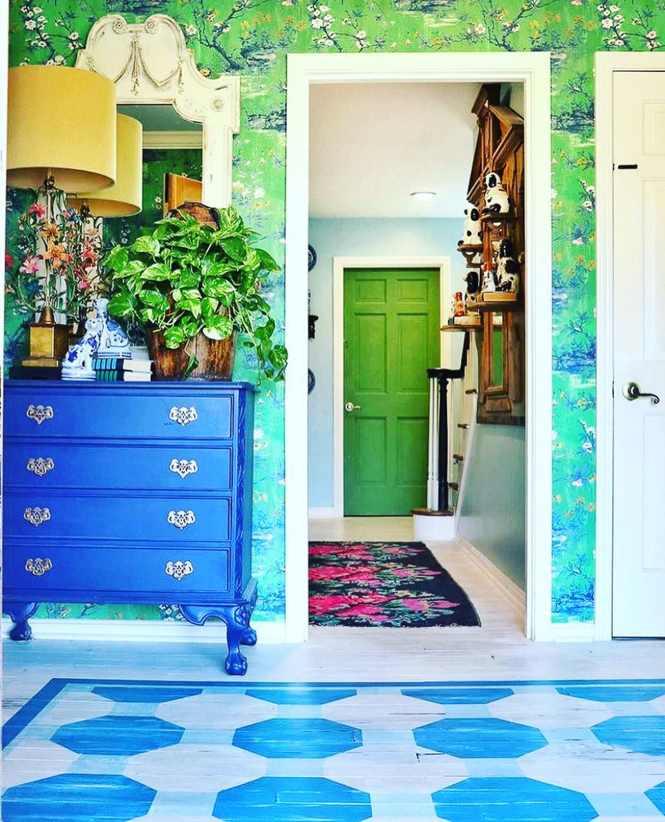 Colorful home tour - love the hand painted wood floor and the green wallpaper in this stunning foyer