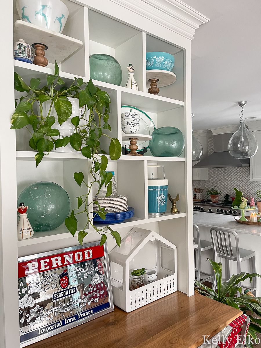 Love this open shelf display of vintage finds including old glass fishing buoys kellyelko.com