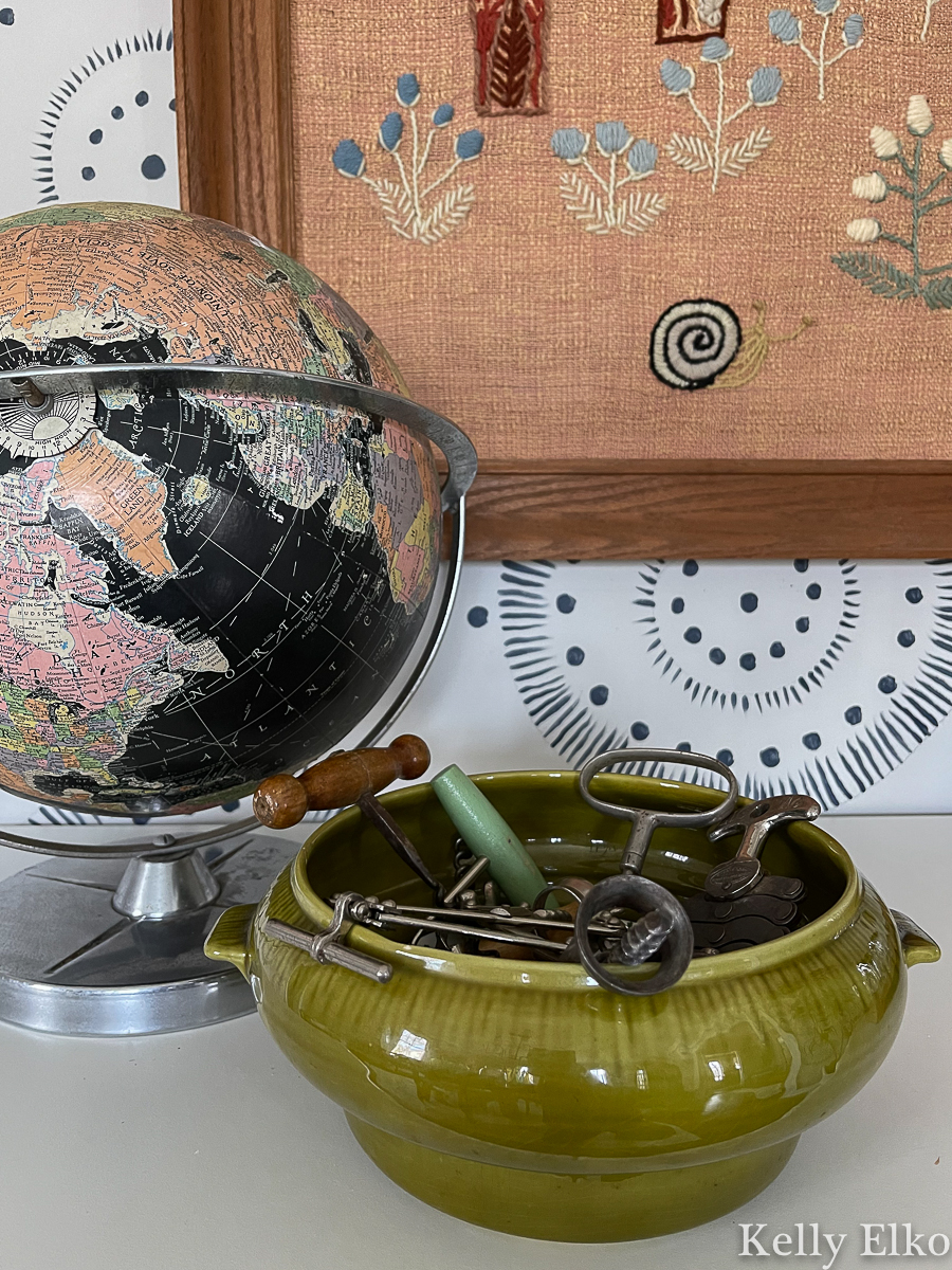 Decorate with vintage - love the black globe and green pottery bowl filled with vintage corkscrews kellyelko.com