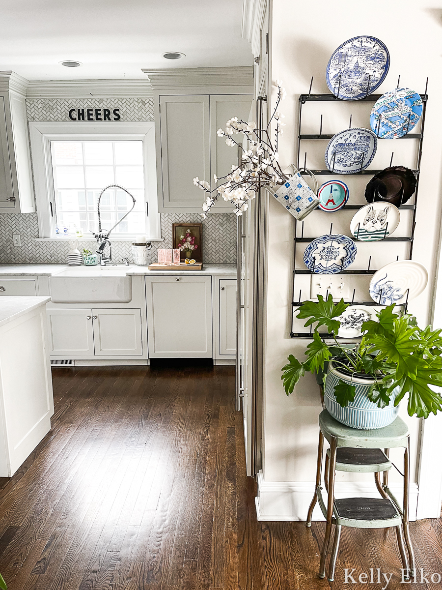 Beautiful white farmhouse kitchen with eclectic plate wall display kellyelko.com