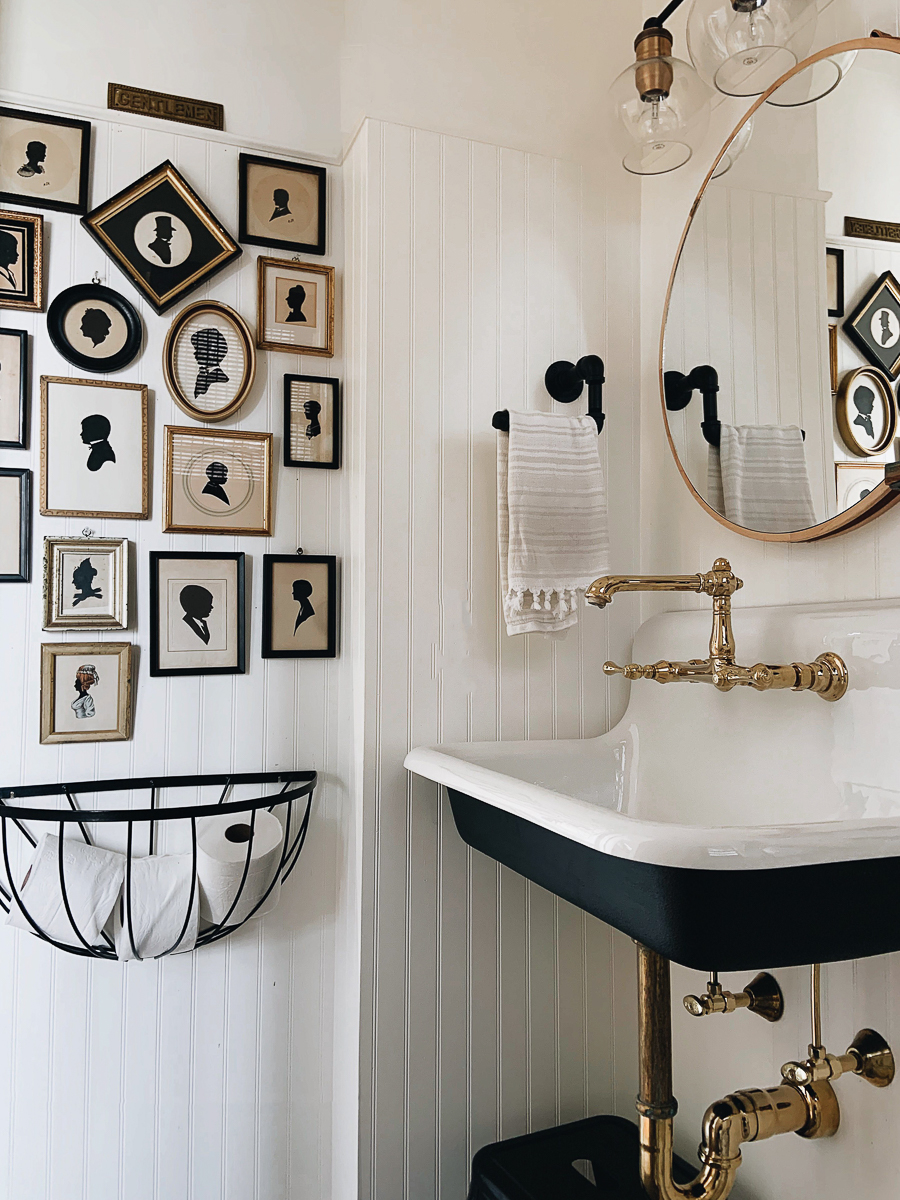 Black white and brass bathroom with antique silhouette art gallery wall kellyelko.com