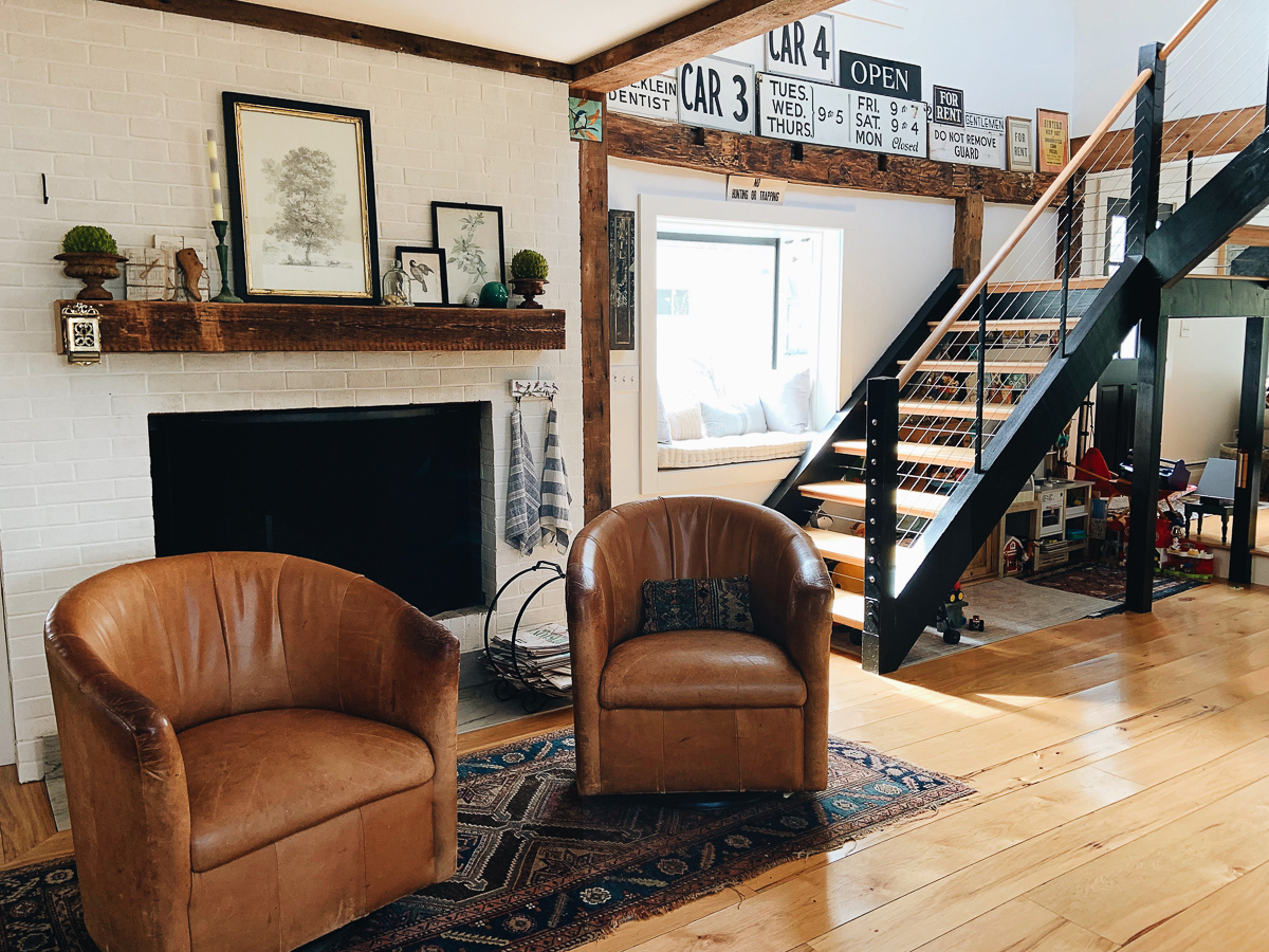 Cozy leather club chairs and graphic vintage signs in this old farmhouse kellyelko.com