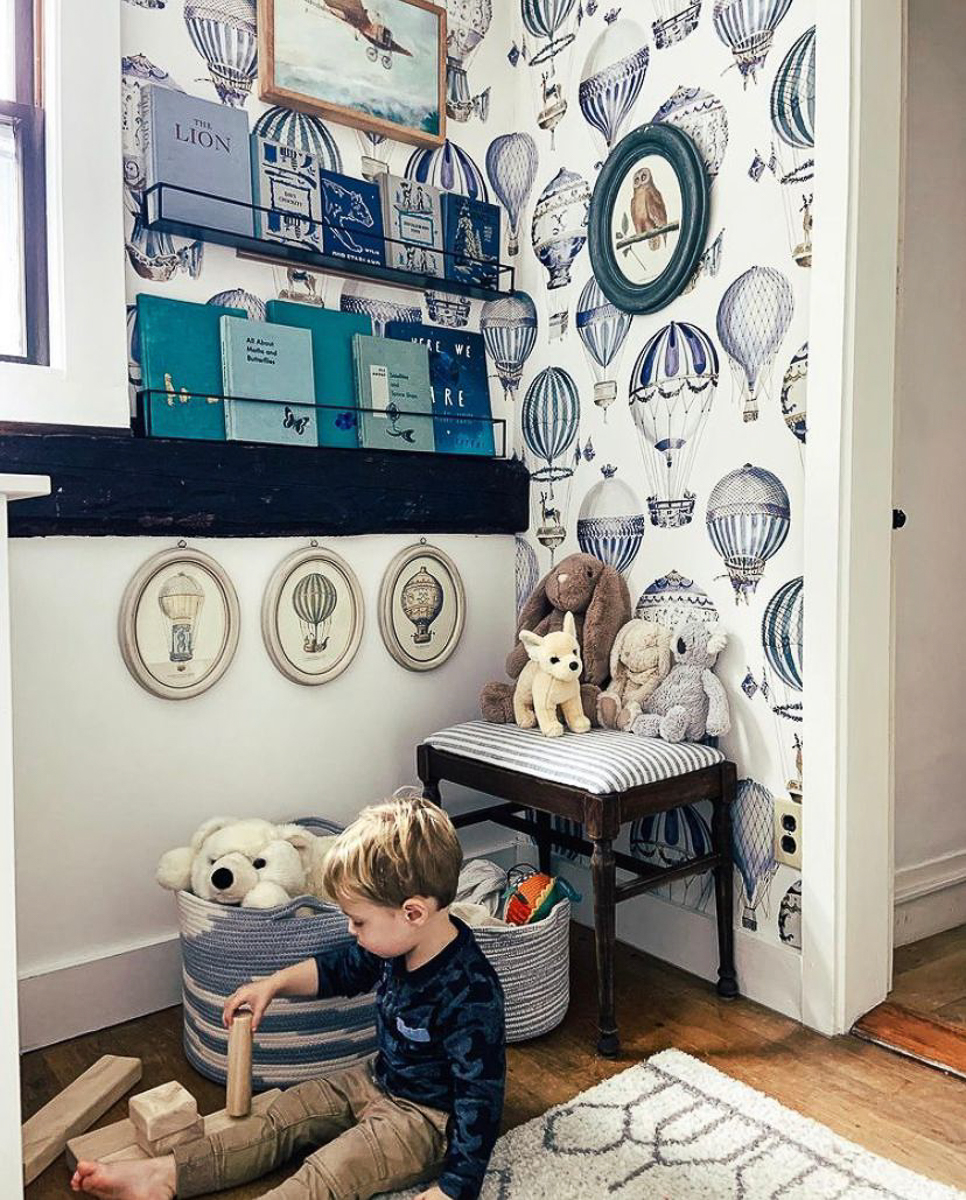 Love the whimsical hot air balloon wallpaper in this cozy kids reading nook kellyelko.com