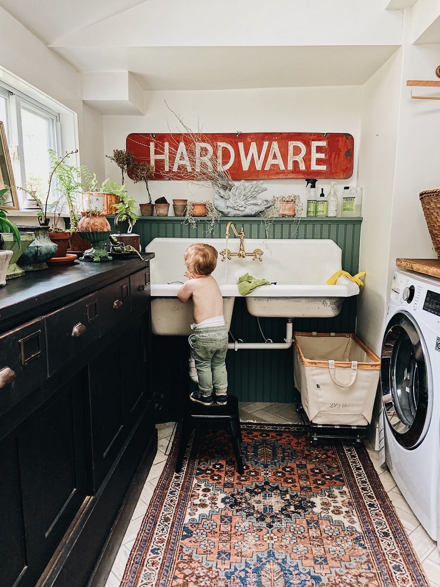 Love this laundry room / potting room complete with antique cabinet, old sink and huge old sign kellyelko.com