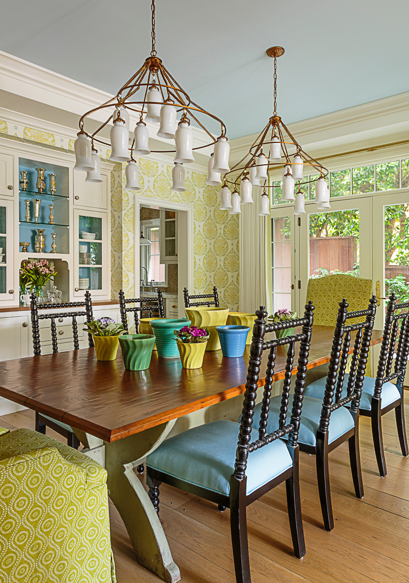 Beautiful and colorful dining room with stunning pair of chandeliers and built in chine cabinet kellyelko.com