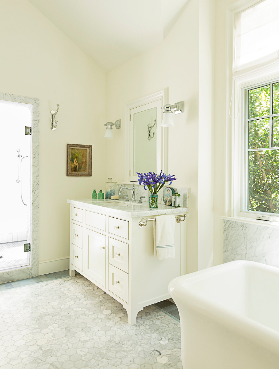 Love this white bathroom with marble floor and freestanding tub kellyelko.com