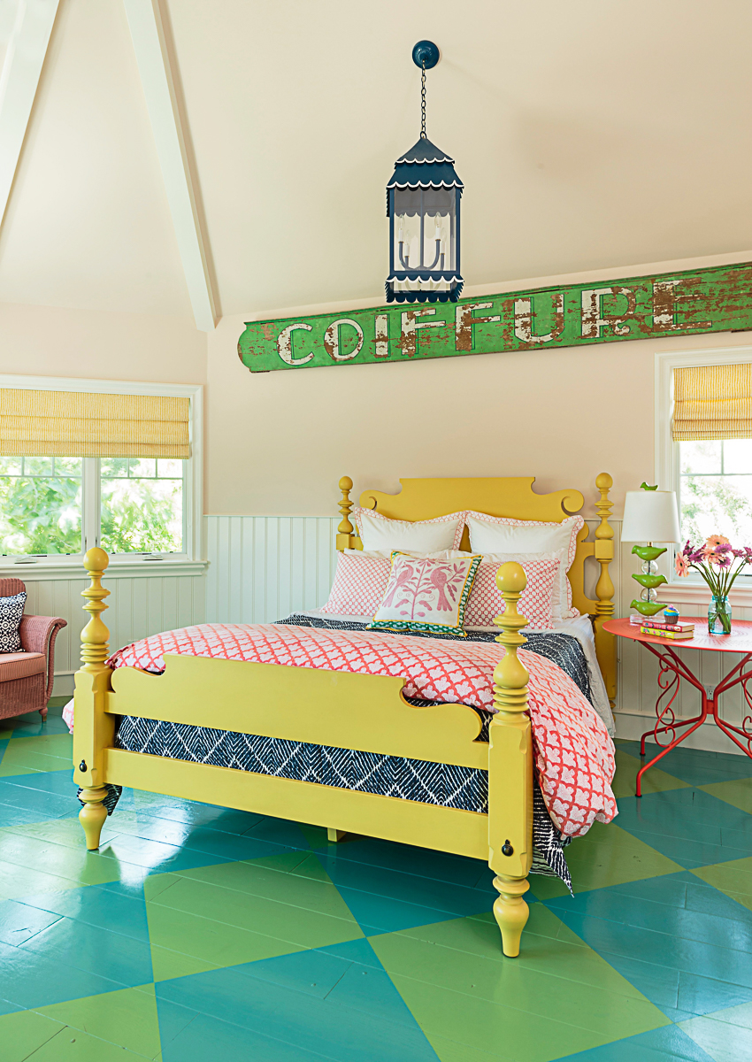 Colorful bedroom with oversized diamond painted wood floor and yellow bed kellyelko.com