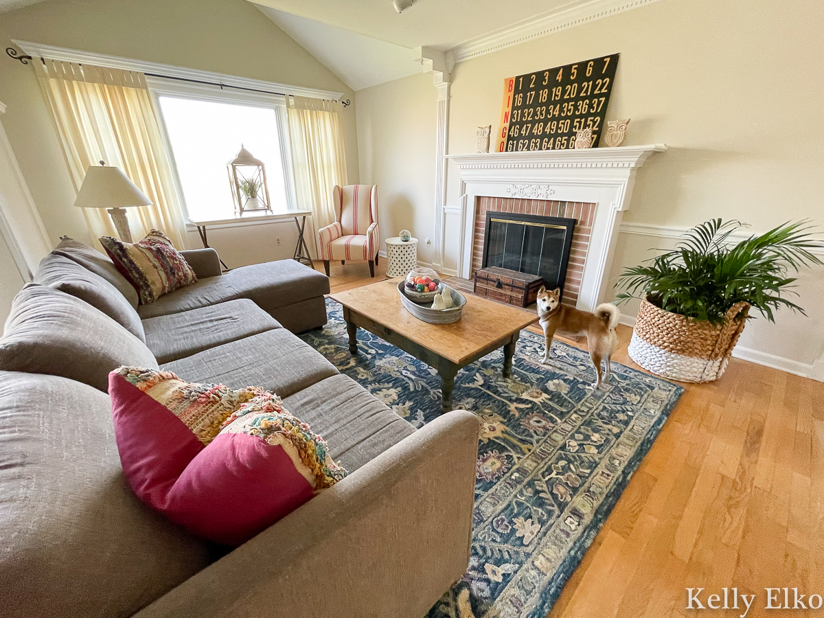 Home Staging After - love the colorful rug and vintage art on mantel kellyelko.com