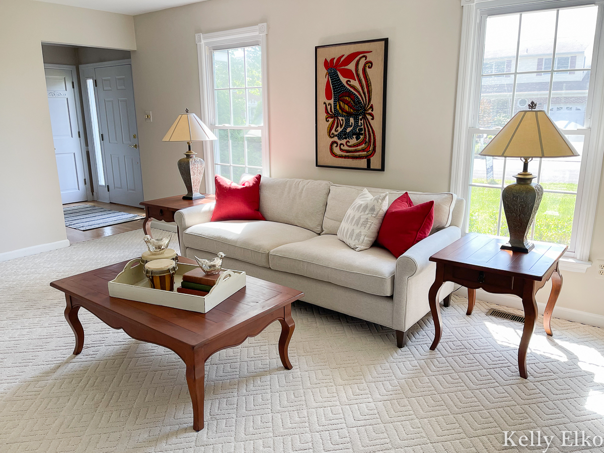 Home Staging - Love this living room with colorful vintage embroidered rooster art kellyelko.com