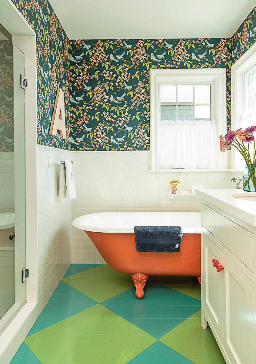 Colorful bathroom with blue and green diamond painted wood floors and orange clawfoot tub kellyelko.com