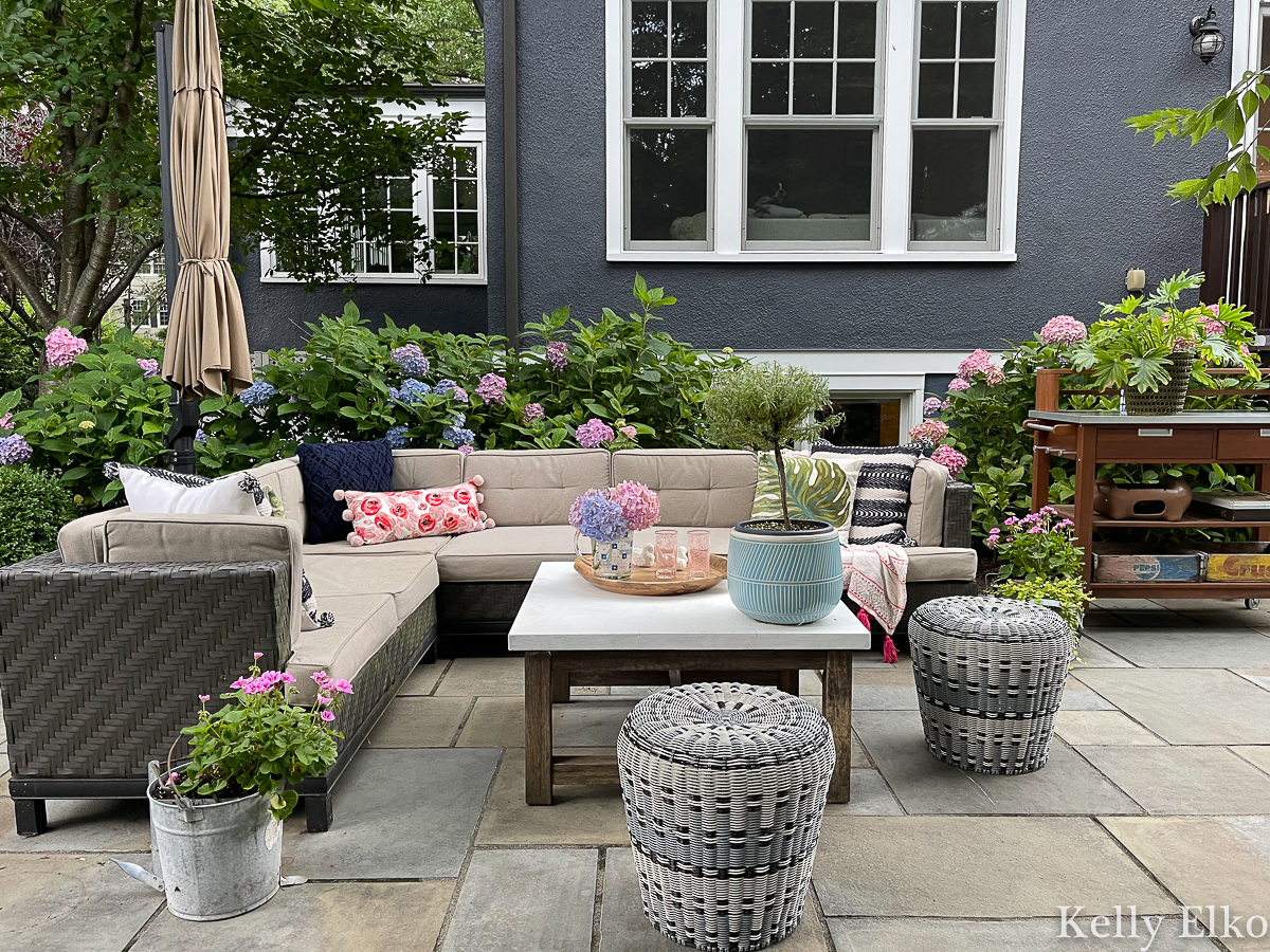 Beautiful bluestone patio with large outdoor sectional sofa and tons of gorgeous hydrangeas kellyelko.com