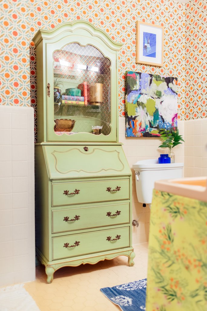 Love this vintage secretary in the bathroom for storage kellyelko.com