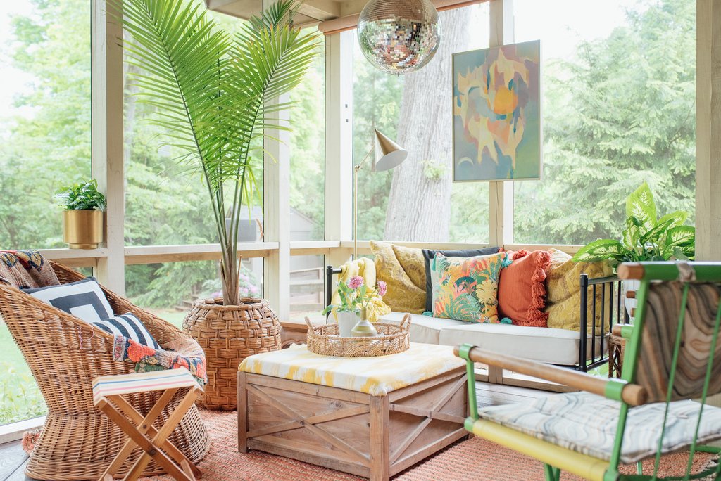 Beautiful boho screened in porch with wicker furniture and a disco ball kellyelko.com