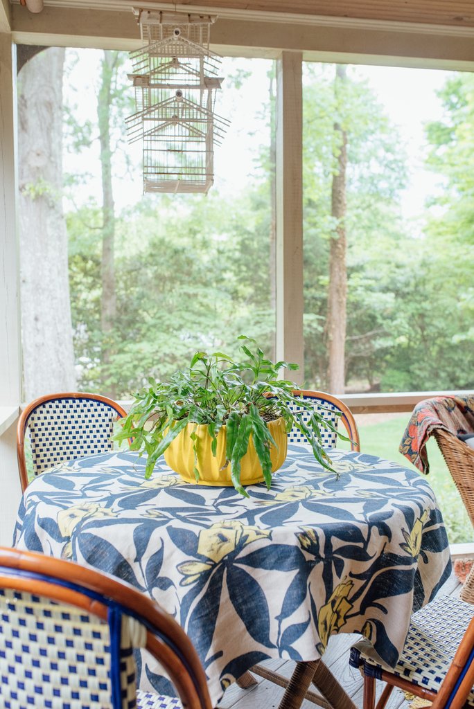 Love this porch furniture with blue bistro chairs and floral tablecloth kellyelko.com