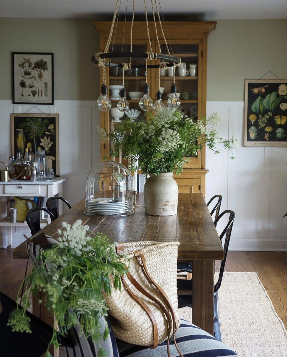 Love this farmhouse dining room filled with flowers and botanical prints kellyelko.com