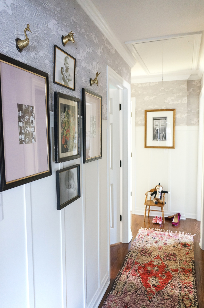 Love this hallway with planked walls, subtle gray wallpaper and gallery wall kellyelko.com