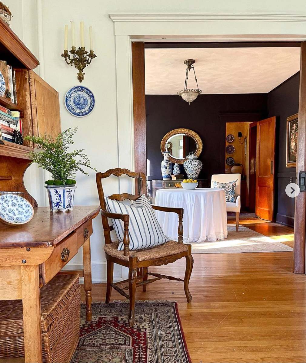 Love this home tour filled with antiques and the dark moody wall paint in the dining room kellyelko.com
