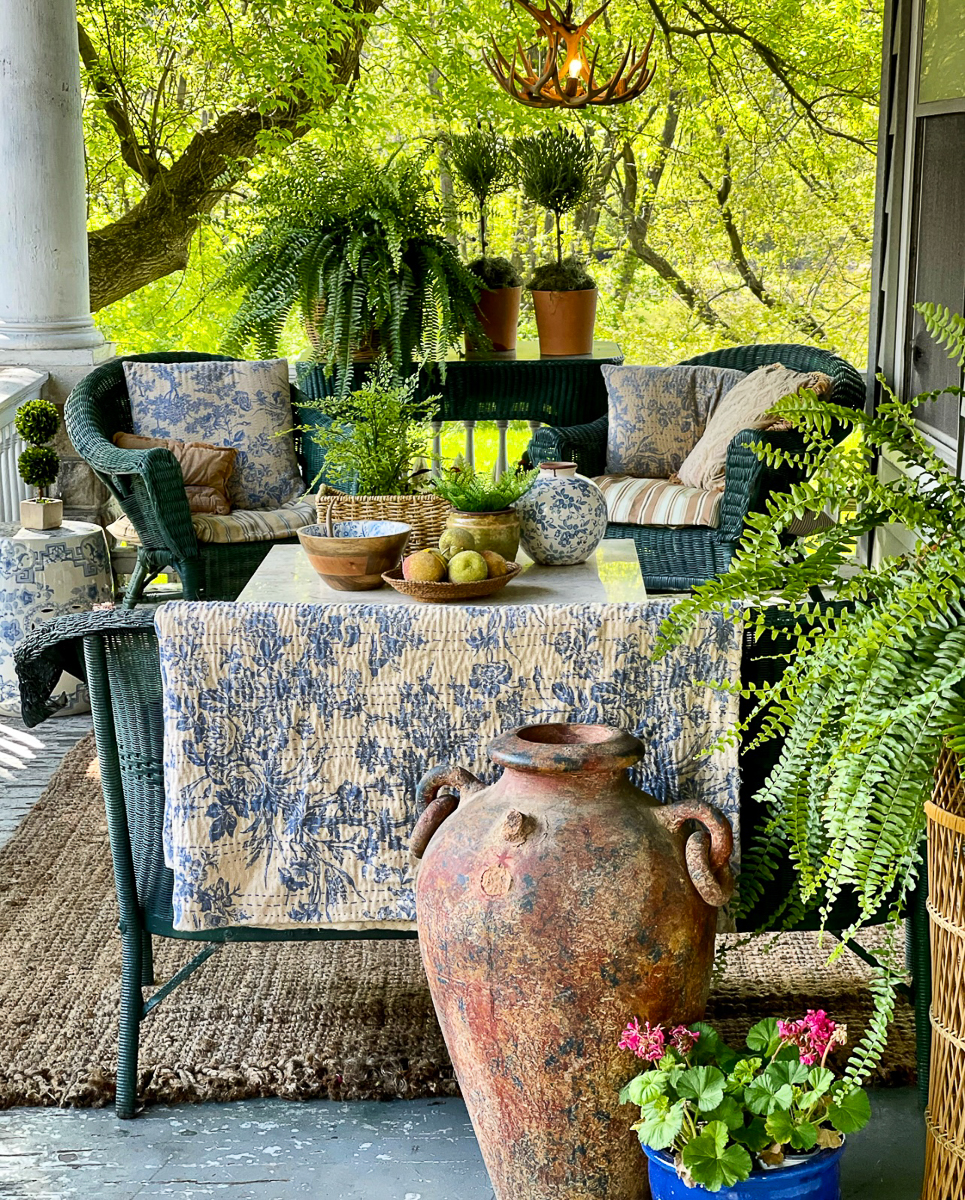 Porch goals - love the eclectic mix of wicker, plants, topiaries, quilts kellyelko.com