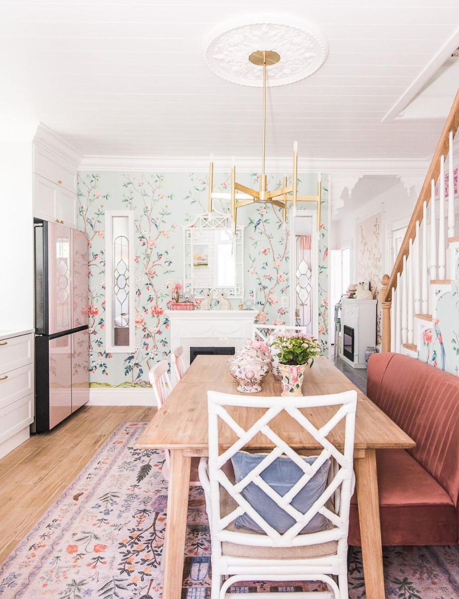 Love this cozy kitchen with banquette seating and pink refrigerator kellyelko.com