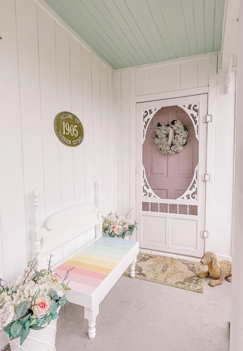 Love this DIY bed turned bench painted in rainbow stripes kellyelko.com