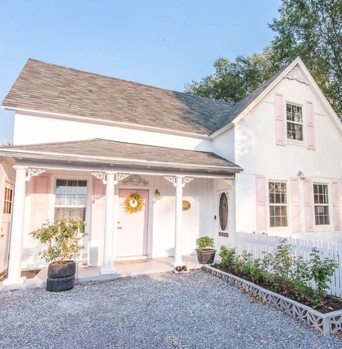 Tour this charming 1905 cottage straight out of a fairytale with pink shutters and door kellyelko.com