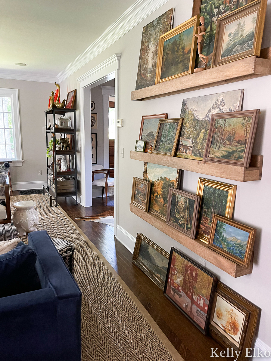 Stunning vintage landscape painting gallery wall - love the picture ledges for changing the look kellyelko.com