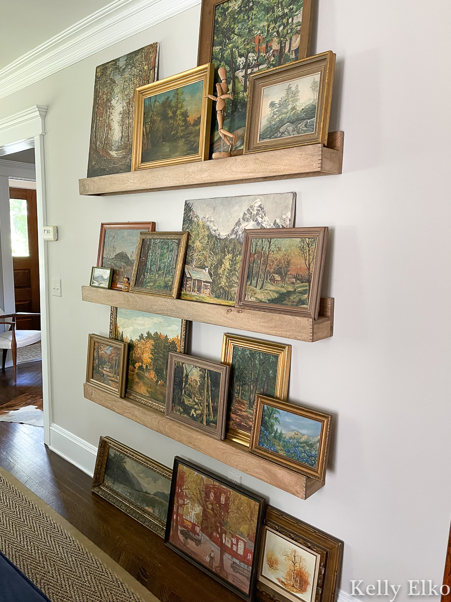 Stunning vintage landscape painting gallery wall - love the picture ledges for changing the look kellyelko.com