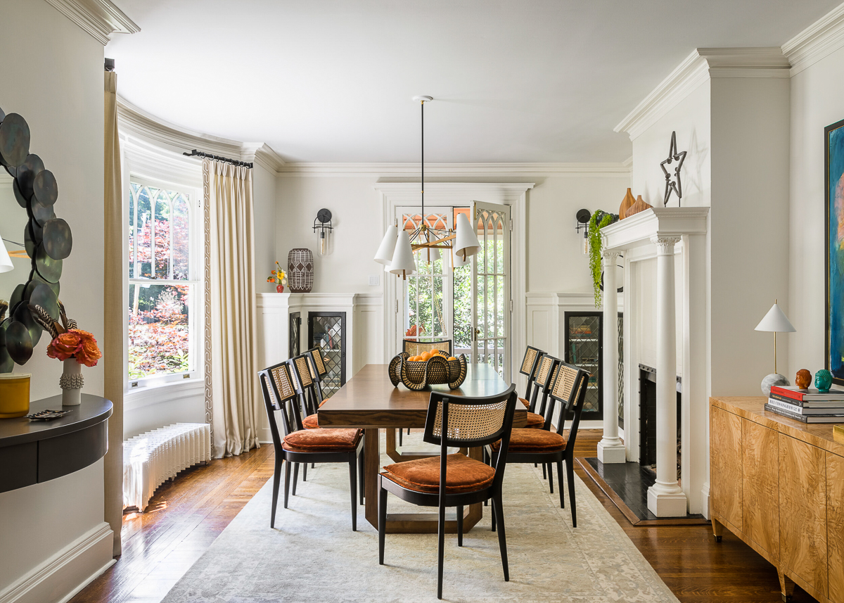 Beautiful neutral dining room with black cane chairs and a burl wood console kellyelko.com