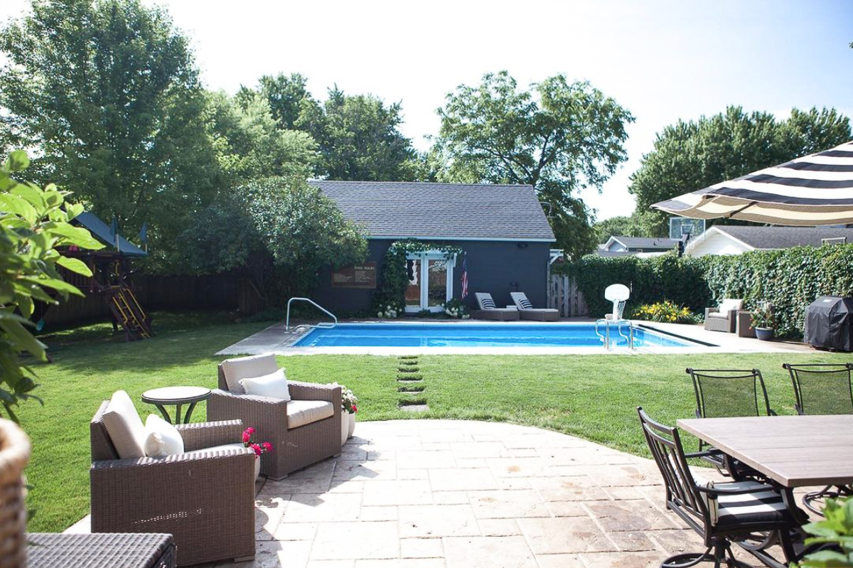 Turn a garage into a pool house by adding doors and a pergola with trailing vines kellyelko.com