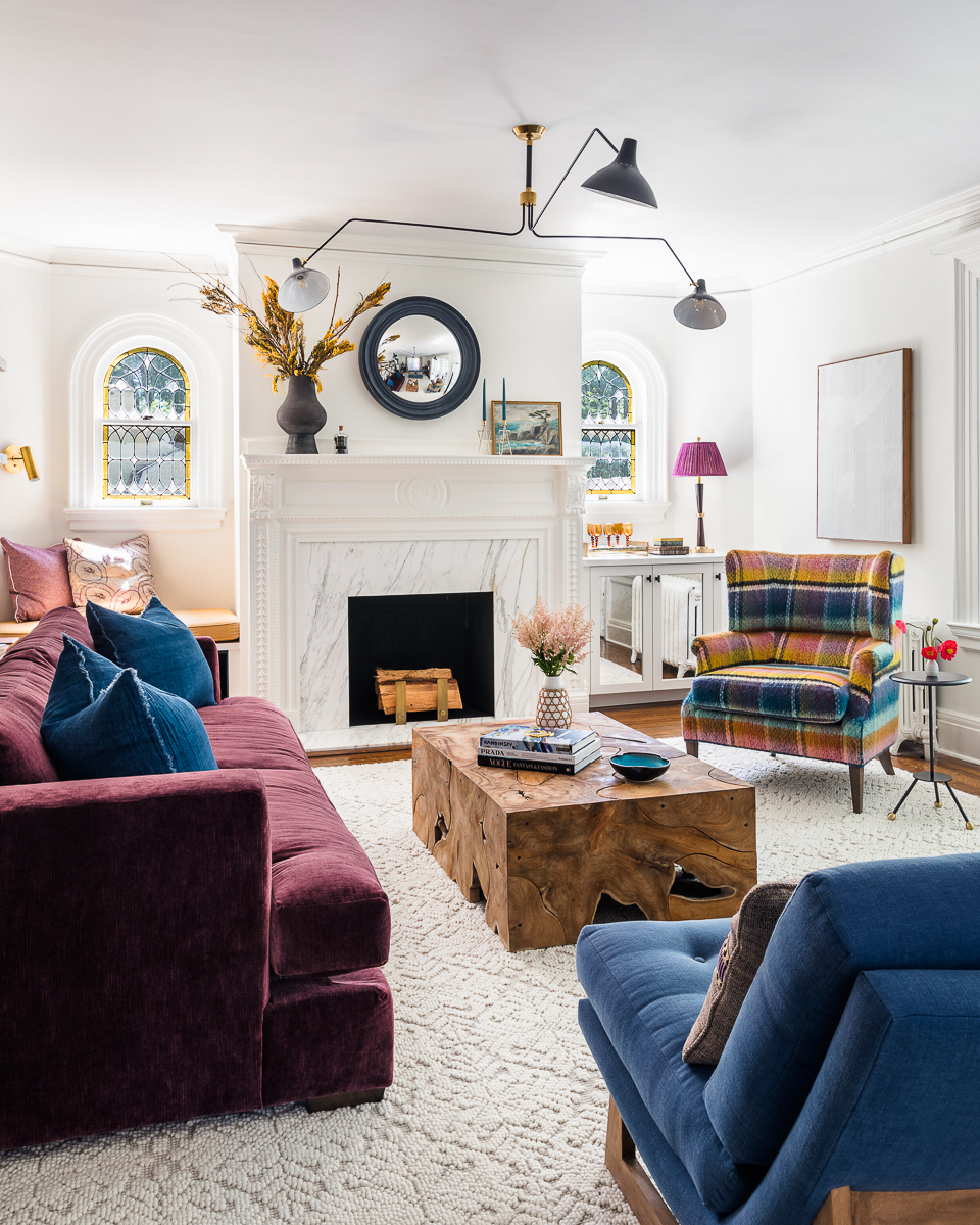 Stunning old home with original stained glass windows with a modern chandelier and colorful velvet furniture kellyelkok.com