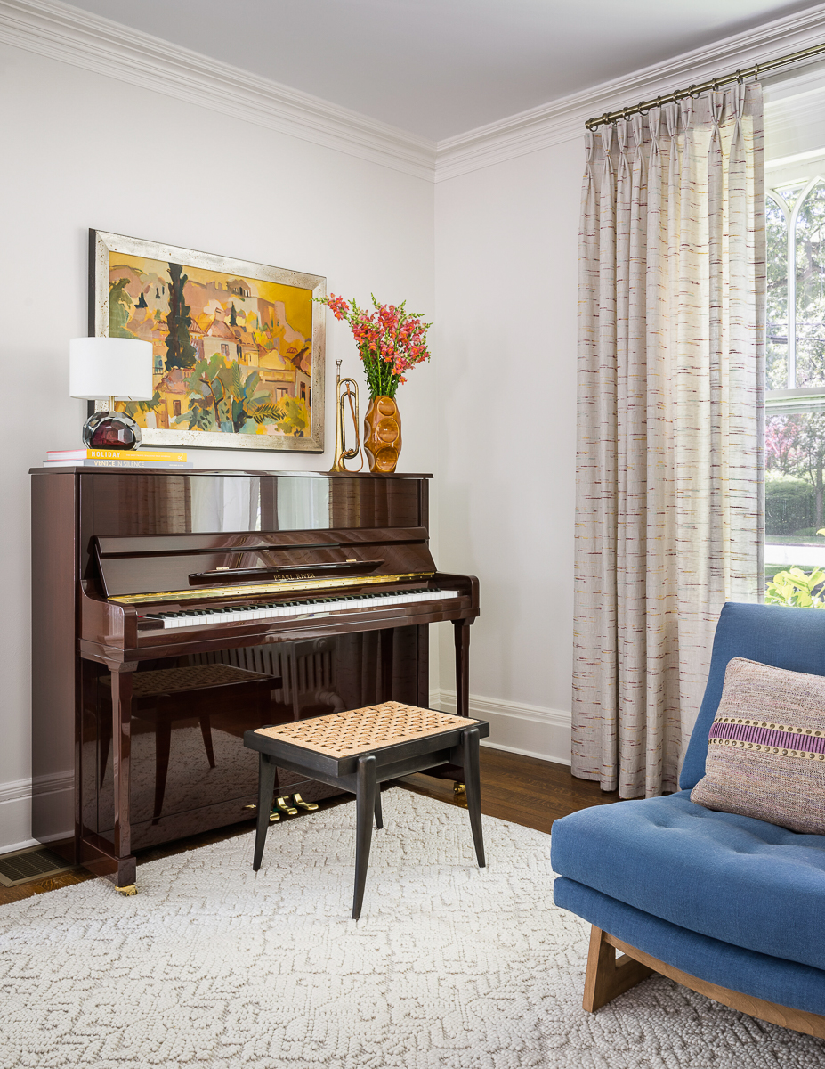 Upright piano with a beautiful piece of art hanging above kellyelko.com