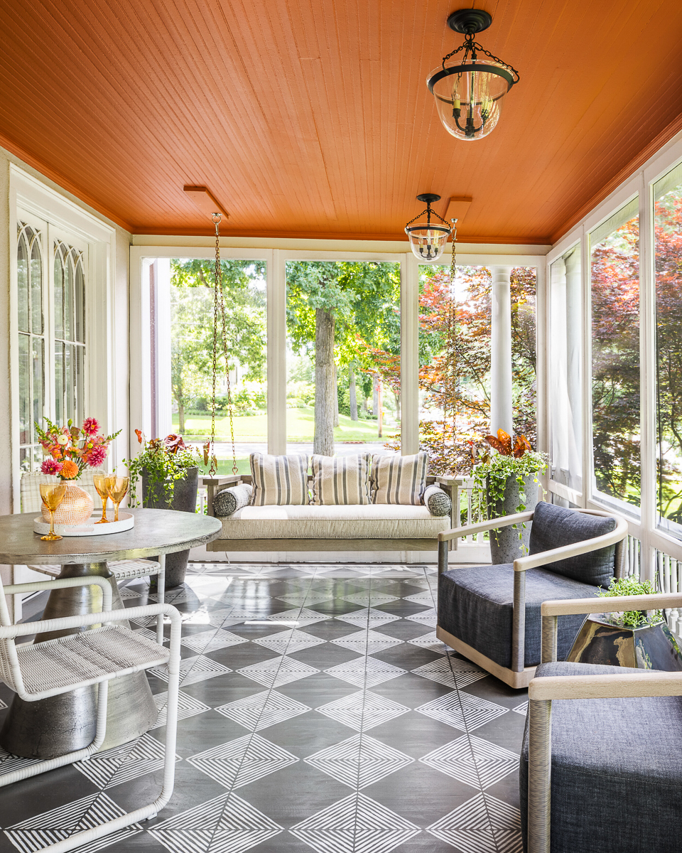 Fun porch with orange ceiling and black and white checkered floors kellyelko.com