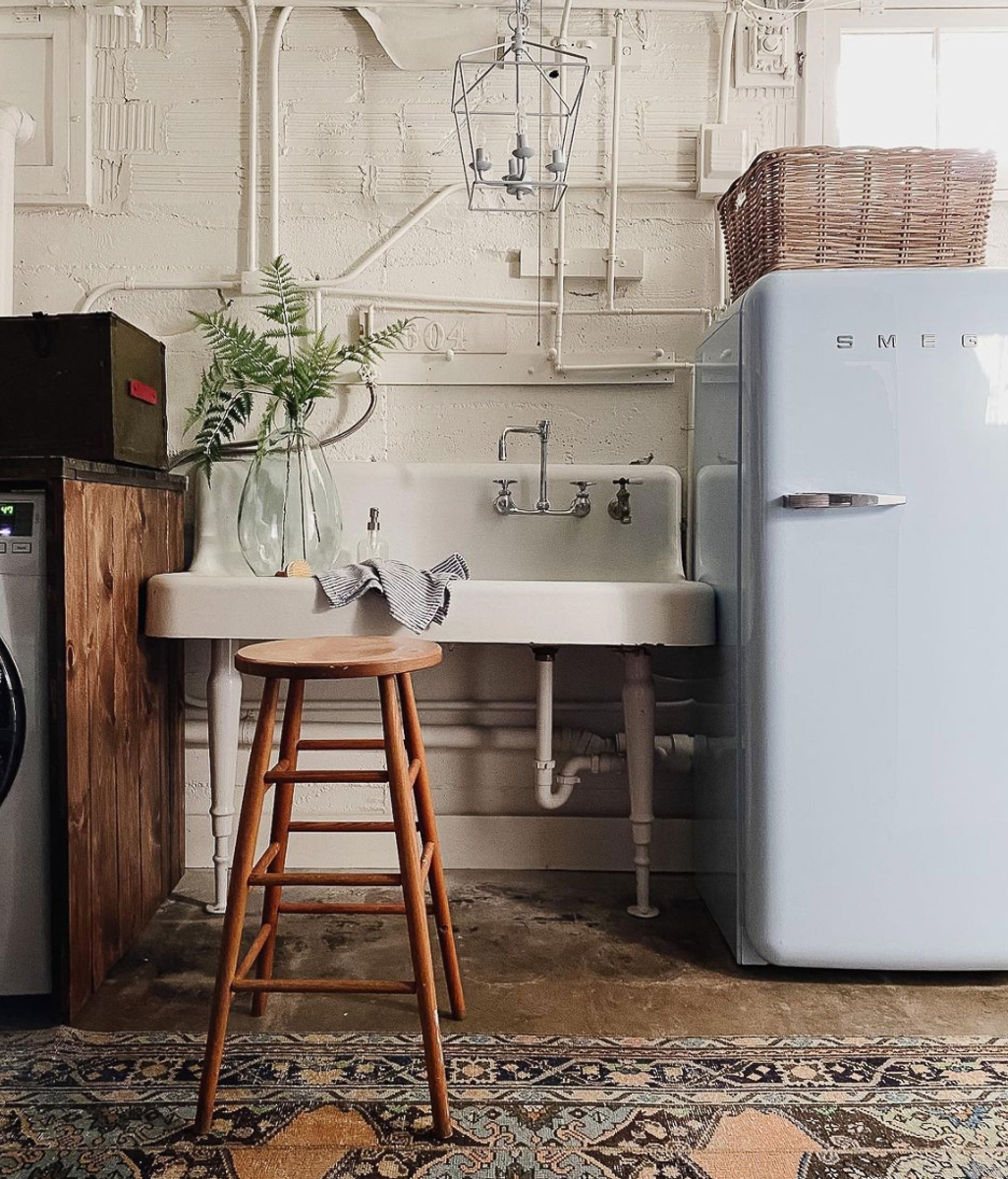 Love this basement laundry room with huge antique sink and Smeg refrigerator kellyelko.com