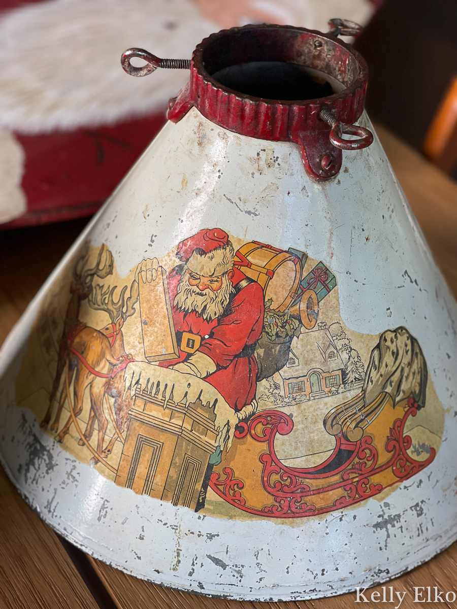 Love this vintage metal Christmas tree stand with a mural of Santa in his sleigh kellyelko.com