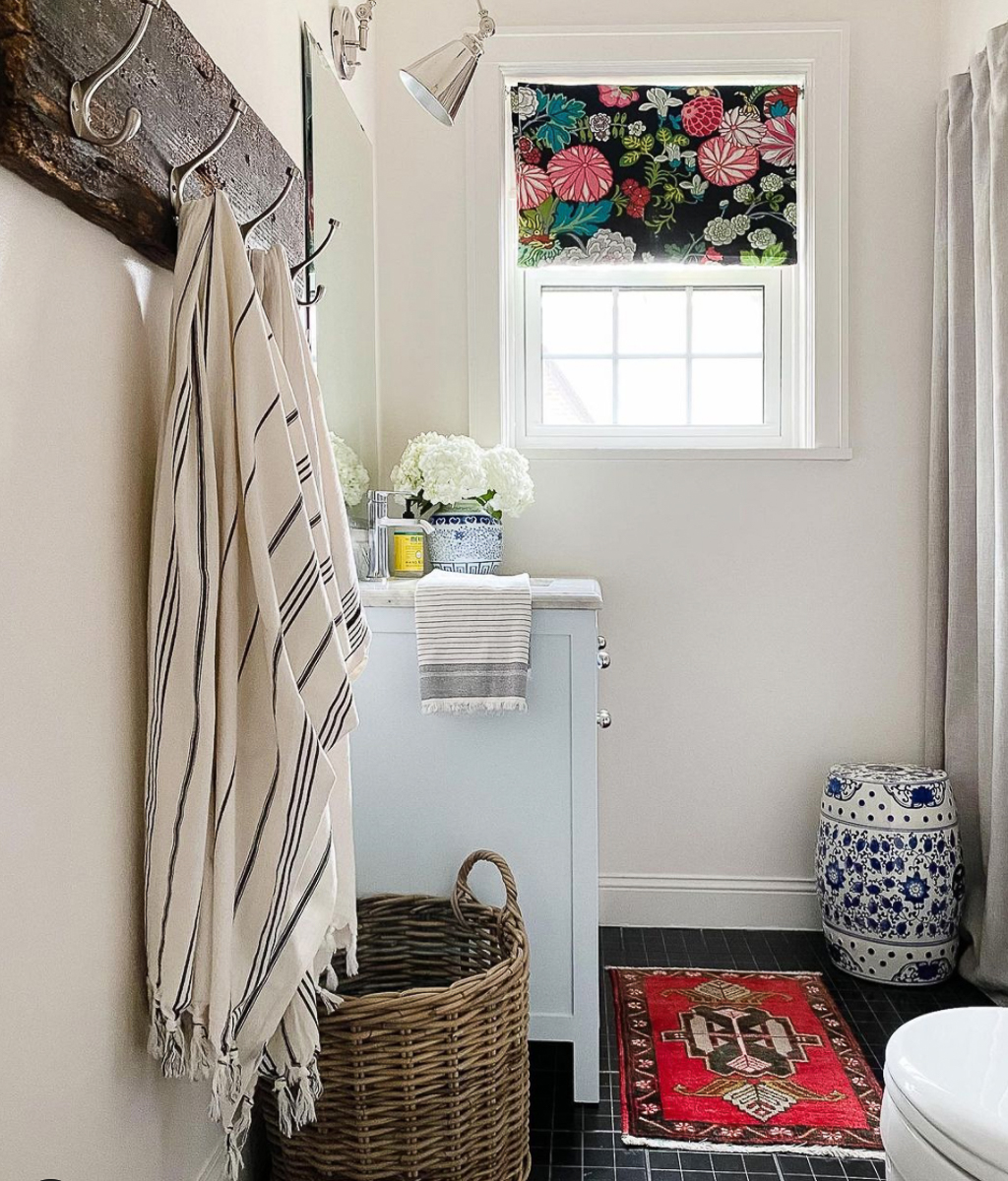 Small bathroom with white walls and black tile floor kellyelko.com