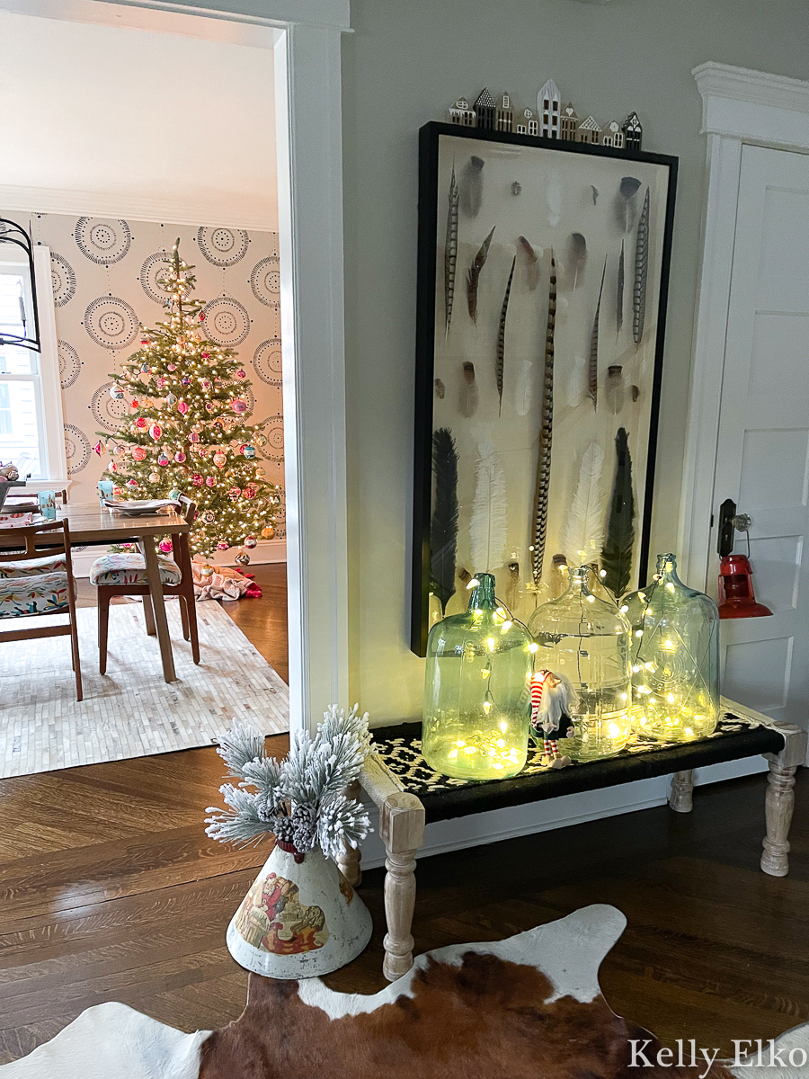 Beautiful Christmas home tour - love the glass jars filled with string lights and the sparse Christmas trees with vintage glass ornaments kellyelko.com