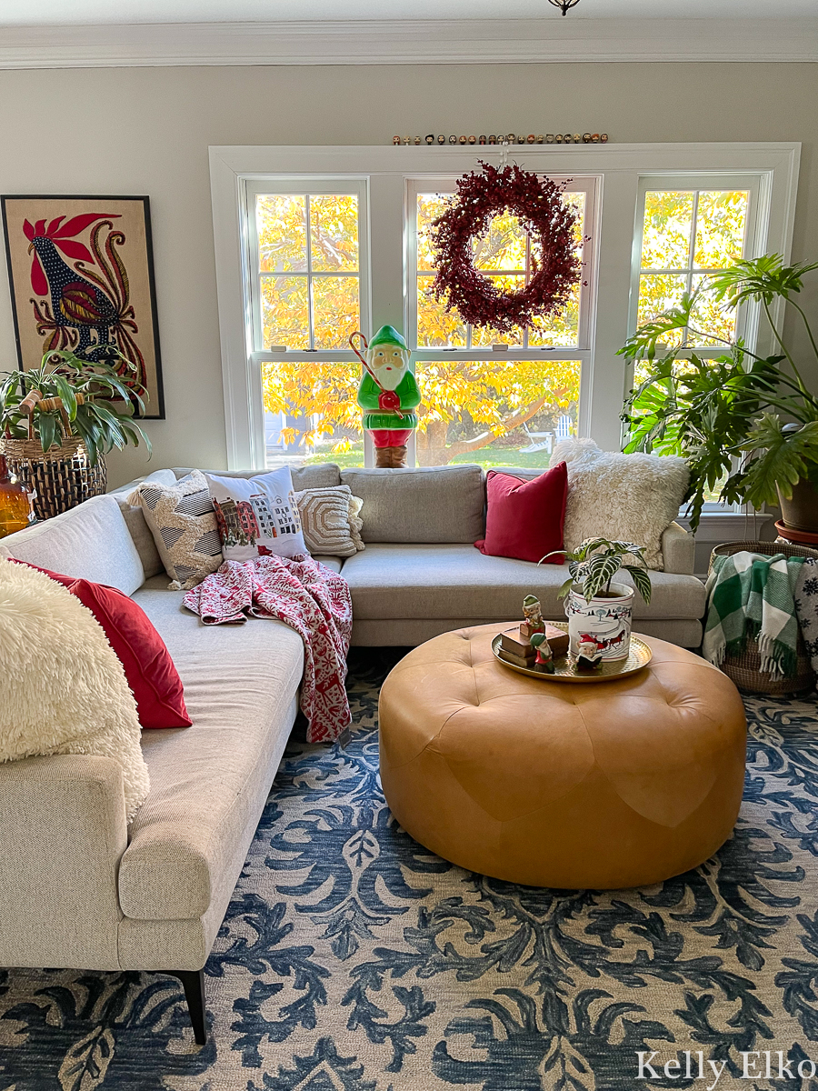 Cozy Christmas family room - love the elf blow mold, berry wreath and cozy throws and pillows kellyelko.com