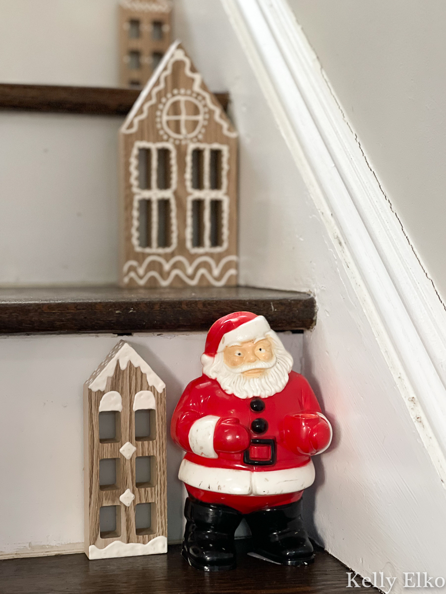 Vintage hard plastic Santa blow mold is cute on the staircase surrounded by DIY wood houses kellyelko.com